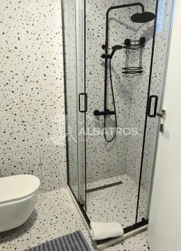 Bathroom with a walk-in shower and terrazzo tiles. - image 10
