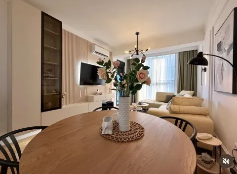 Modern living room with a dining table and decorative flowers. - image 2