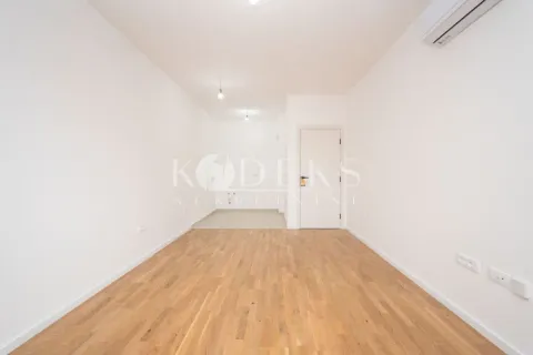 Empty bright room with hardwood flooring and an air conditioner. - image 8