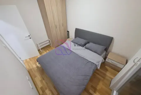 Furnished bedroom with a double bed, wardrobe, and nightstand. - image 7
