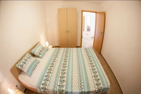 Furnished bedroom with a double bed and a wardrobe. - image 4