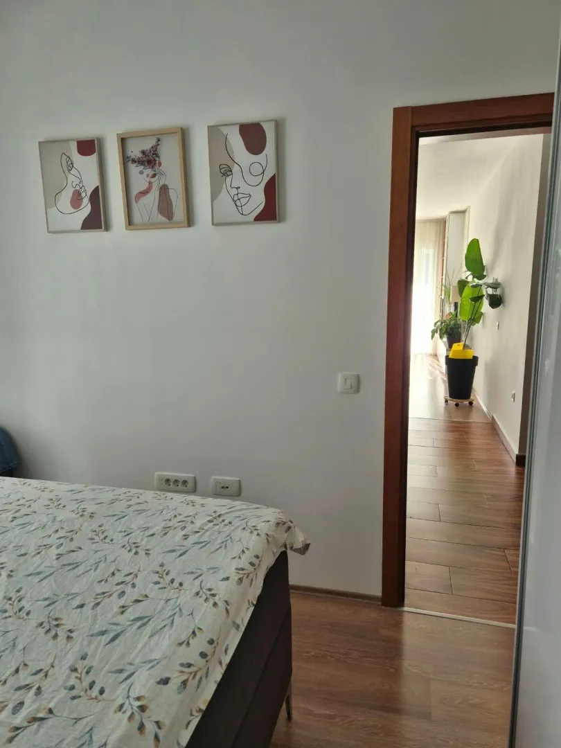 View of the bedroom with a bed and decorative pictures on the wall.