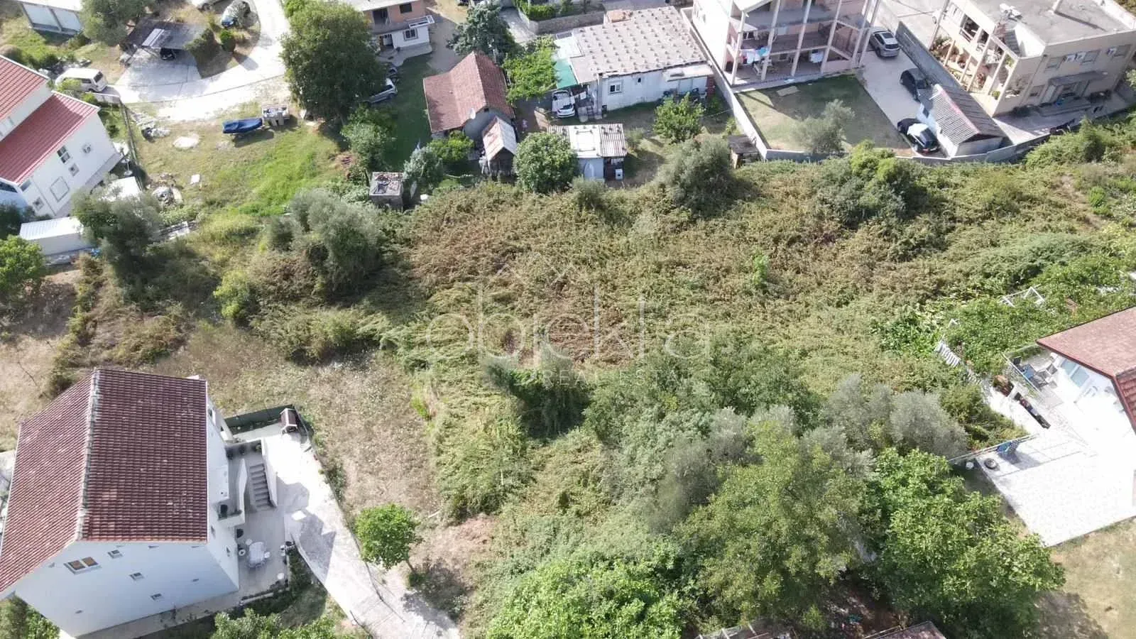 Pogled iz vazduha na zemljište i okolne kuće.