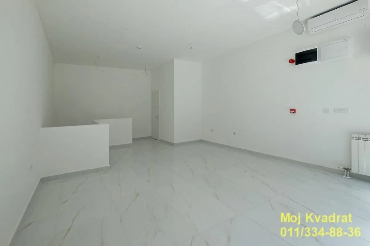 Empty bright room with white walls and tiled floors.