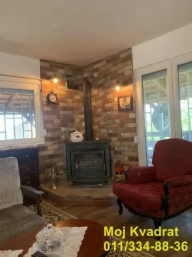 Living room with a fireplace and brick wall. - image 19