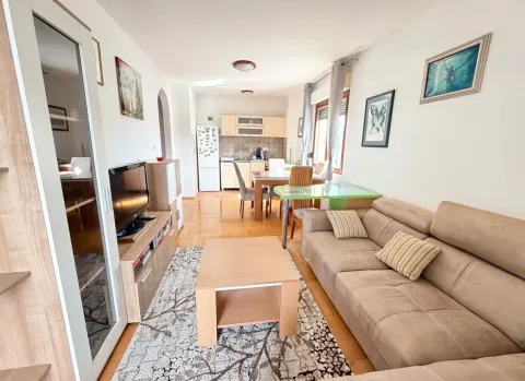 Living room connected with the dining area and kitchen in the background. - image 2