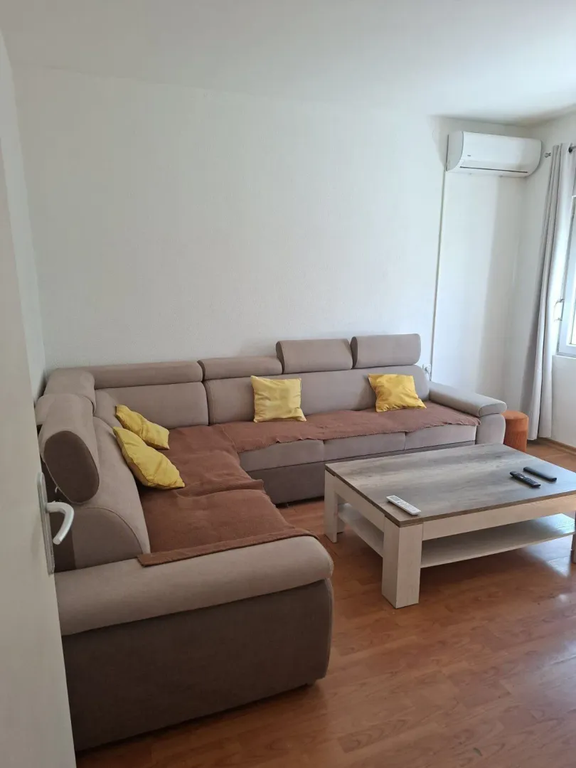 Living room with a corner sofa and coffee table.