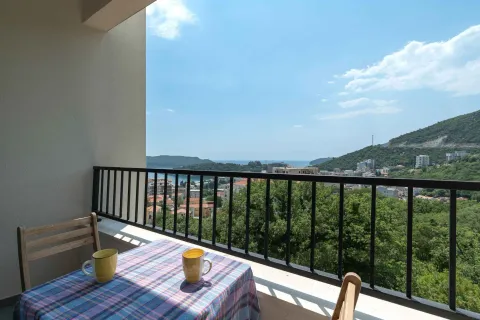 Furnished balcony with a table and a view of the sea and nature. - image 17