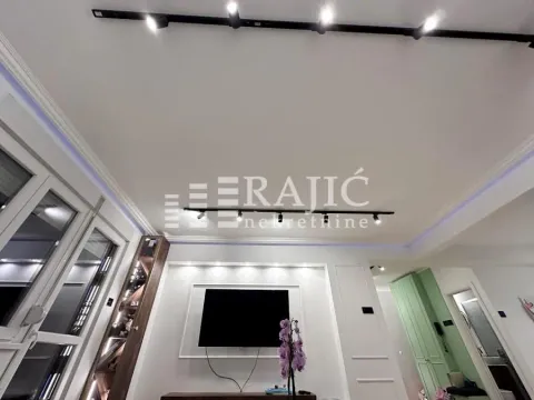 View of the ceiling and living room wall with lighting and a television. - image 8