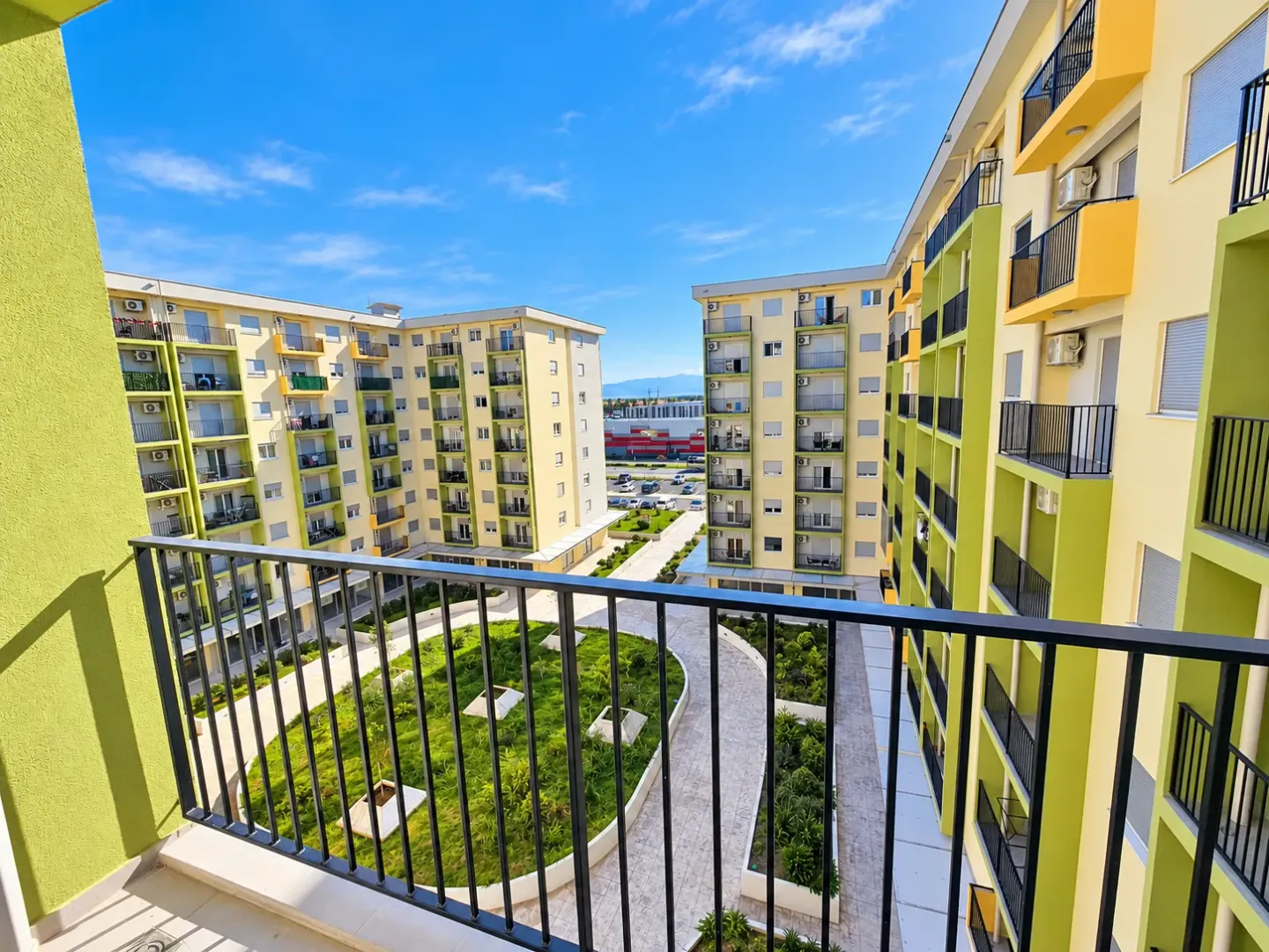 View from the balcony overlooking the courtyard and surrounding residential buildings.