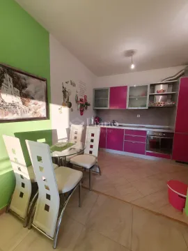Kitchen with a dining area and pink cabinets. - image 4