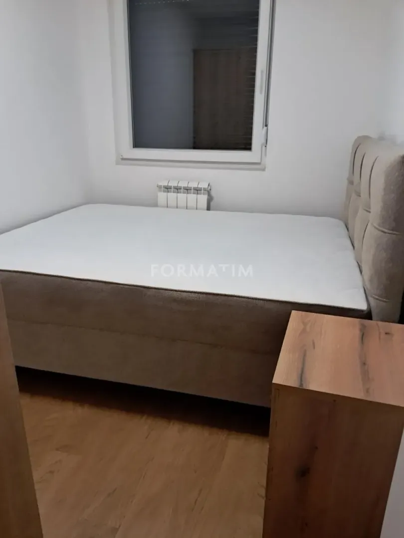 Smaller bedroom with a double bed and a window.