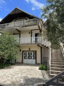 Exterior view of the house with a yard, terraces, and external stairs. - image 2