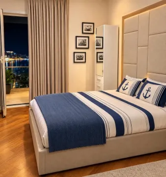 Decorated bedroom with a double bed and sea view from the terrace. - image 9