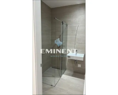 Modern bathroom with a shower cabin and a washbasin. - image 4
