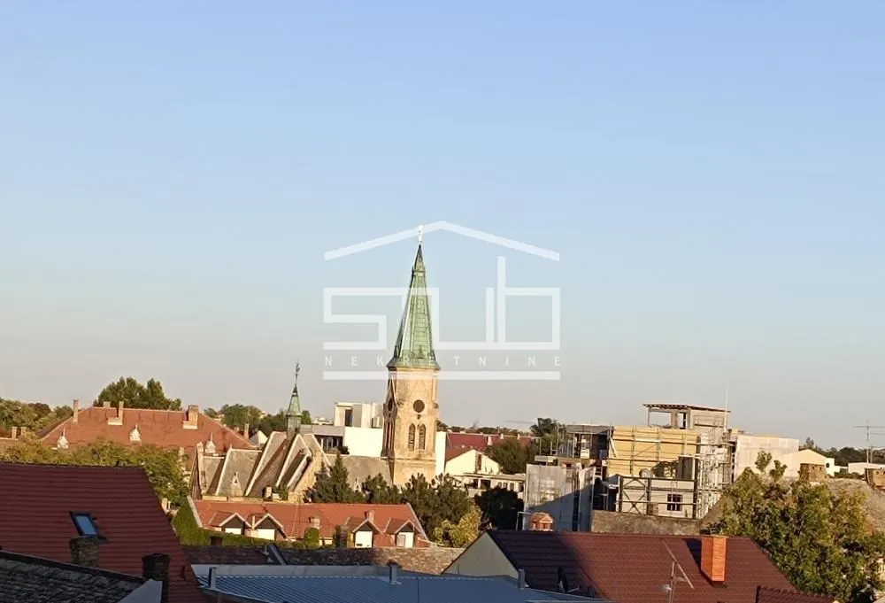 View from the window overlooking rooftops and the city church.
