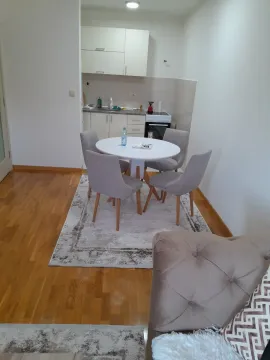 Small kitchen with a dining table and chairs. - image 3