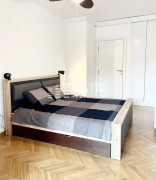 Bedroom with a double bed, parquet flooring, and a built-in wardrobe. - image 8