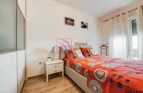 Bedroom with a double bed, bedside table, and built-in wardrobe. - image 8