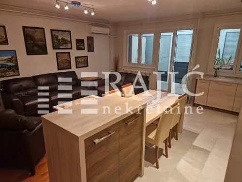 Spacious living room with sofa set and dining area.
