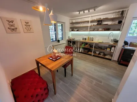 Kitchen with open shelving and a dining table. - image 14