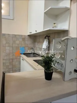 Small kitchen with white cabinetry and a sink. - image 16
