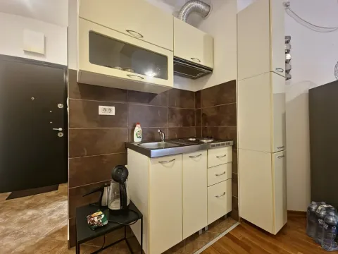 Small kitchen with light-colored cabinets and a sink. - image 5