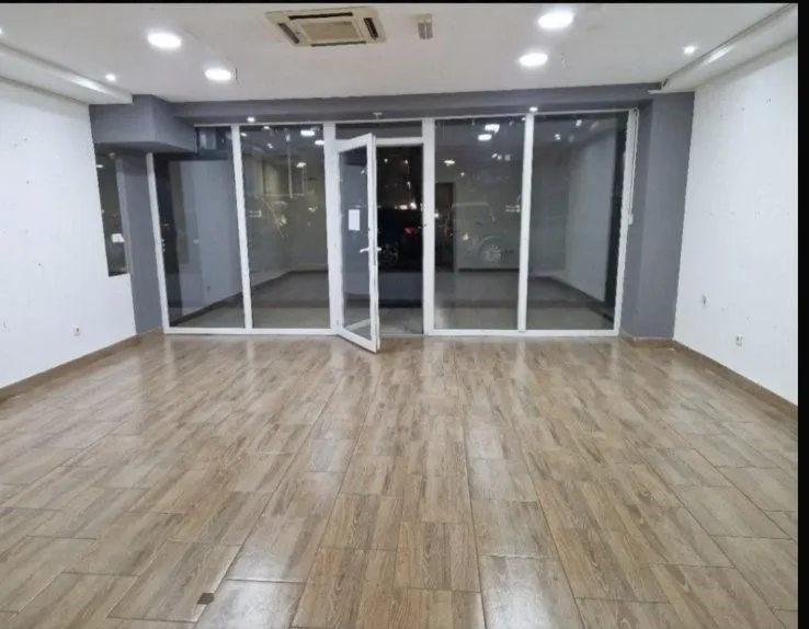 Empty commercial space with glass storefront.