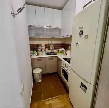 Small kitchen with white cabinets and a white refrigerator. - image 5