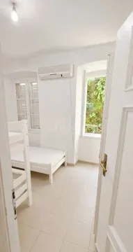 A view of a bedroom with a bunk bed through an open door. - image 9