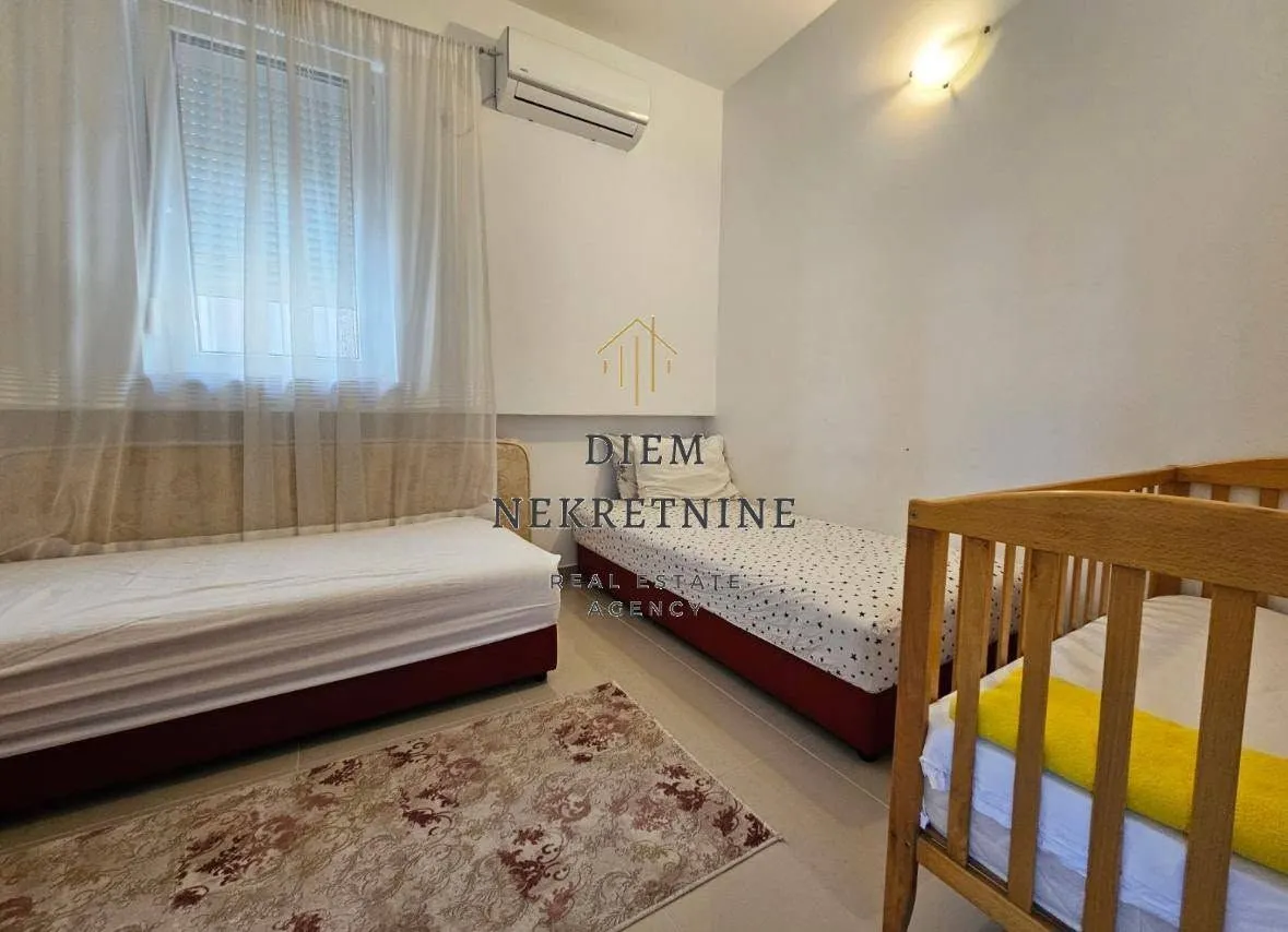 Children's bedroom with beds and a crib.
