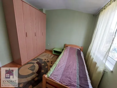 Small bedroom with a bed, large wardrobe, and a window. - image 19