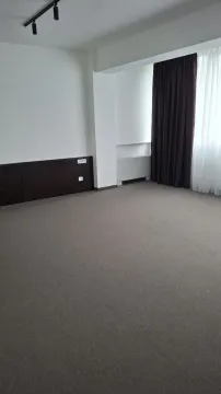 An empty room with grey carpeting and dark curtains. - image 5