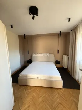 Bedroom with a double bed and parquet flooring. - image 8