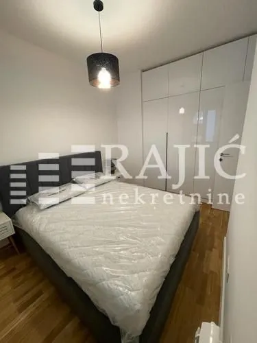 Modern bedroom with a double bed and built-in wardrobe.