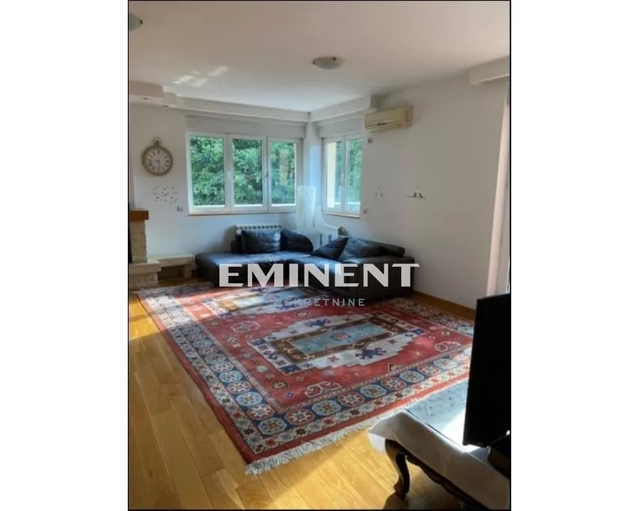 Living room with a sofa set and a large rug on the floor.