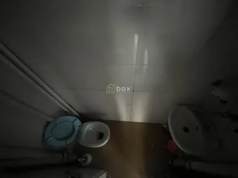 Top-down view of a small equipped bathroom with a toilet and washbasin. - image 5