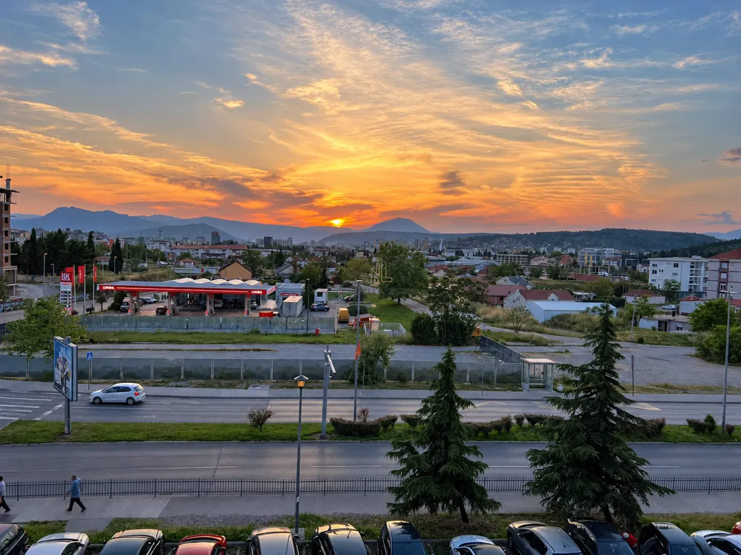 View from the property of the city and mountains during sunset.
