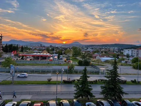 View from the property of the city and mountains during sunset. - image 8