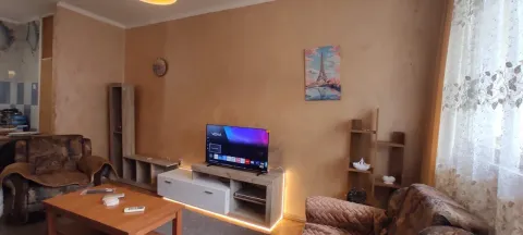 Living room with a sofa set, television, and wooden furniture. - image 3