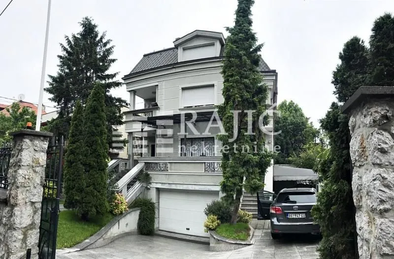 Front exterior of a multi-family house with a courtyard and garage.
