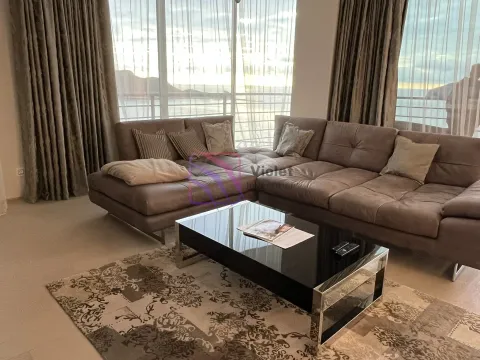 Comfortable living room with a large sectional sofa and sea view. - image 9