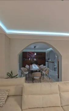View from the living room towards the dining area with a table and chairs. - image 11