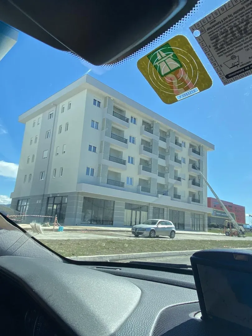 A new residential building photographed from inside a car.