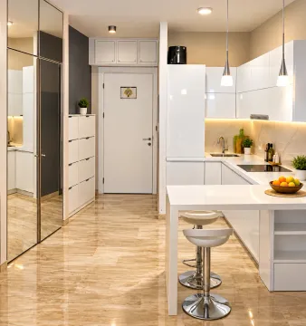Modern white kitchen with an island, bar, and stools. - image 5
