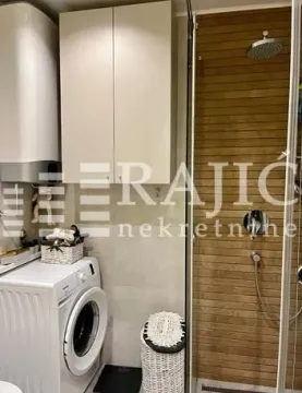 Compact bathroom with a shower cabin and a washing machine. - image 9