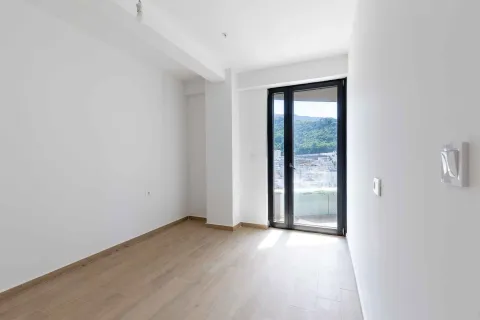 Prazna svijetla soba sa drvenim podom i balkonskim vratima. - image 12