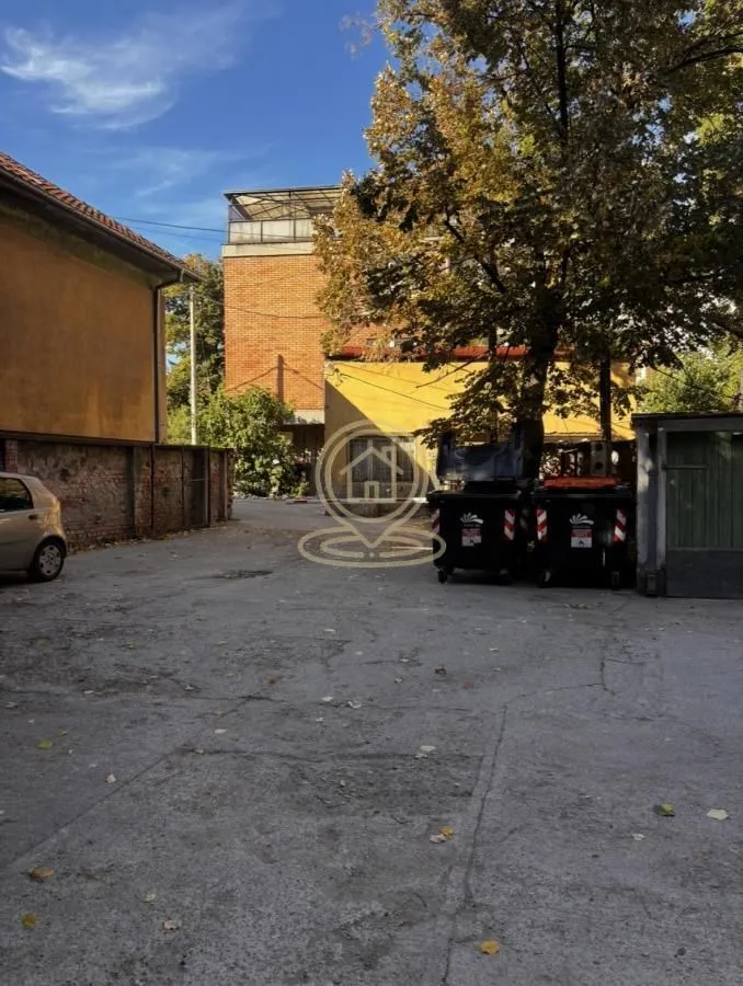 View of the courtyard and surrounding buildings with parking space.