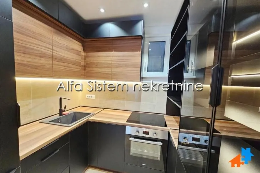 Modern kitchen with wooden elements and built-in appliances.