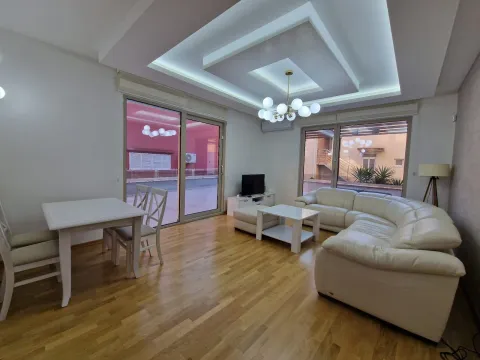 Spacious living room with a sofa set, dining table, and access to the terrace. - image 11
